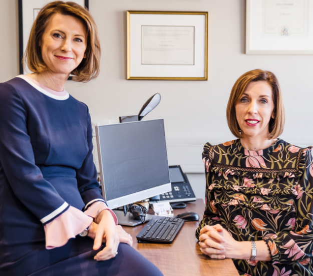 Dr Louise Newson and Dr Rebecca Lewis at a desk